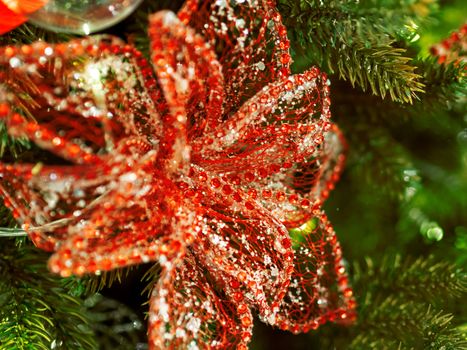 Elegant flower, made of fabric with sequins. New Year decoration for Christmas tree.