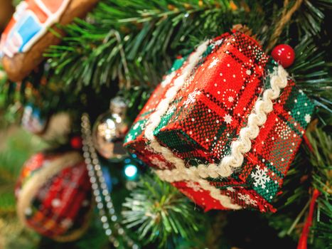 Hand made decoration for Christmas tree. Decoration made of tartan fabric with spangles for New Year celebration.