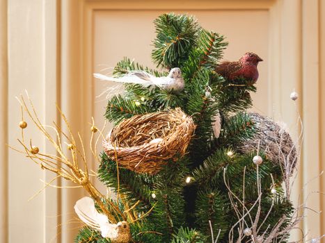 Sparkling artificial birds and nestles, decoration for Christmas tree. Traditional decoration for New Year celebration.