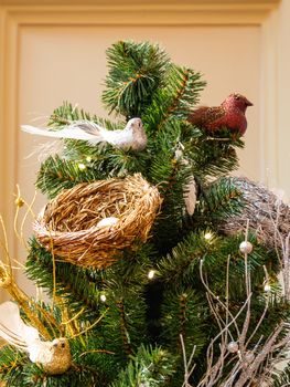 Sparkling artificial birds and nestles, decoration for Christmas tree. Traditional decoration for New Year celebration.