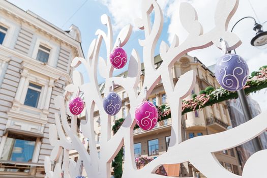 Street festival "Moscow Spring". Easter decoration of colorful fair. People walking on sunny day.