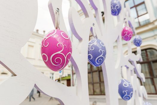 Street festival "Moscow Spring". Easter decoration of colorful fair. People walking on sunny day.