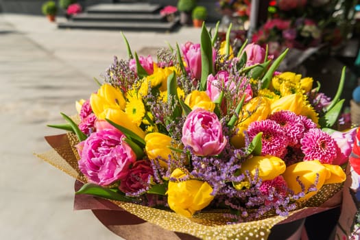 Bouquet with tulips and ranunculus. Spring sunny day.