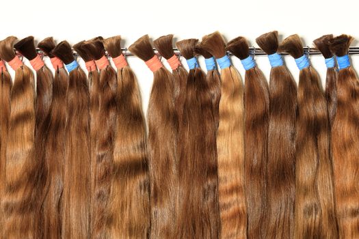 Haircare female hair, technology, style and beauty concept. Natural chocolate colored shiny healthy human hair bundles for extension and weave wigs making.