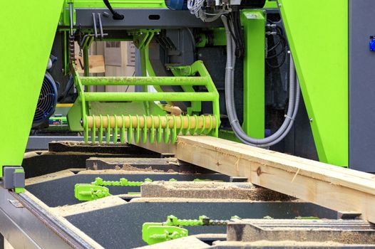 Woodworking, fresh lumber, pine boards are made at a modern automatic sawmill.