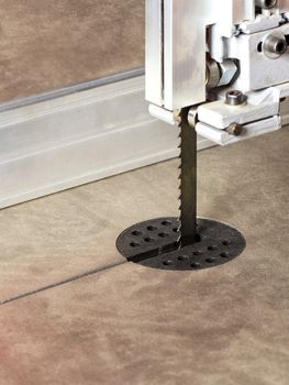 The sharp teeth of the band saw on a modern woodworking machine provides high precision cutting, close-up.