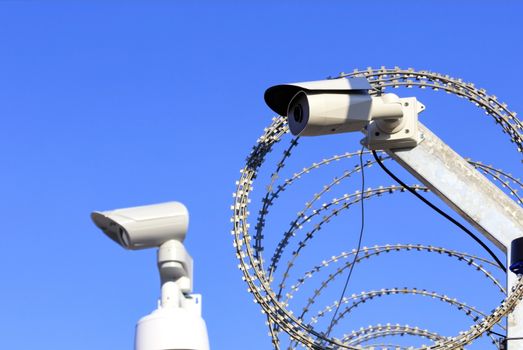 Territory perimeter security. Barbed wire fence and cameras protect against intruders.