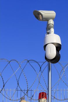 Perimeter security. Barbed wire fencing, a red signal light and cameras protect against intrusions.