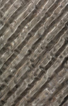 Wood ribbed background texture and background of polished and waxed walls. Ribbed mosaic carved wood with a green pearl shade in the form of diagonal lines.