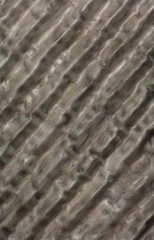 Wood ribbed background texture and background of polished and waxed walls. Ribbed mosaic carved wood with a green pearl shade in the form of diagonal lines.