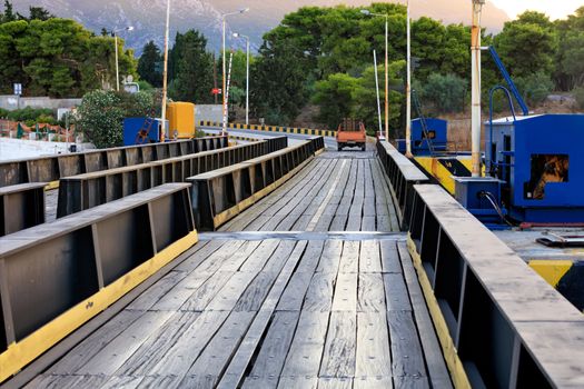 An automobile and pedestrian bridge over the Corinth Canal in Greece, which is flooded as ships and boats pass through the canal, image with copy space.