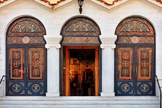 Three doors of the Ekklisia Agios Ioannis Orthodox Church in Loutraki, the middle door is open, August 15, 2019, Greece. Greece