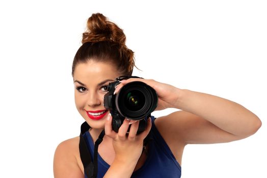 Photographer occupation concept - beautiful and attractive woman holding a professional DSLR camera and smiling