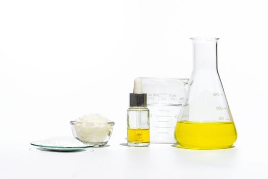 Cosmetic chemicals ingredient on white laboratory table. Emulsifier, Ethanolamine, Acid, Cetyl Alcohol, Yellow cosmetic color (oil), Microcrystalline wax 