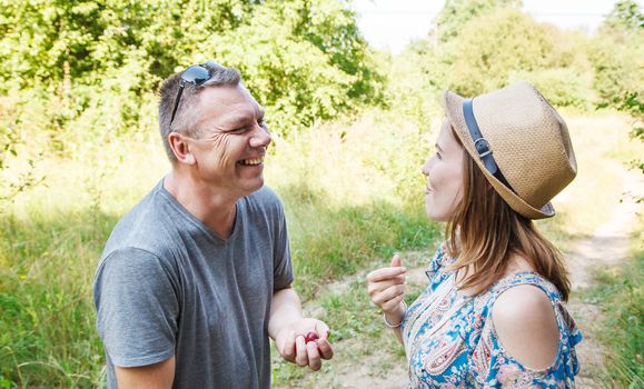 couple of lovers talk laughing in the forest on sunny summer day