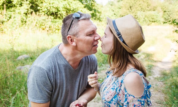 pair of lovers kissing in the forest on sunny summer day