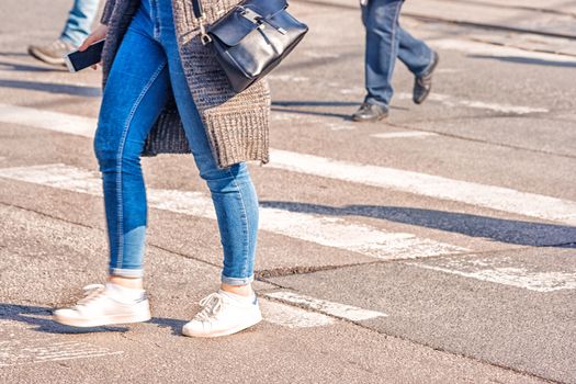 crossroad with walking pedestrians on sunny spring day