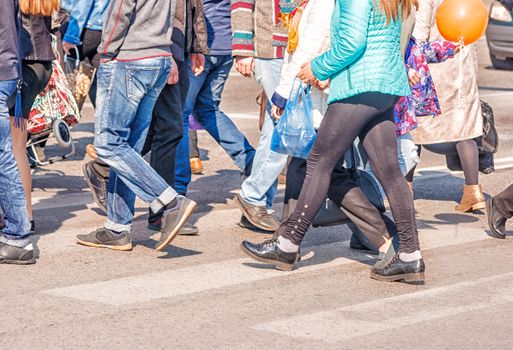 crossroad with walking pedestrians on sunny summer day