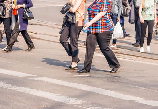 road crossing with women, pedestrian feet on sunny spring day