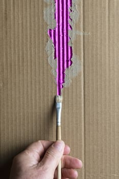 paint a torn corrugated cardboard with a brush