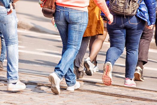 road crossing with woman, pedestrian feet on sunny spring day