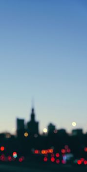 Blurry cityscape silhouette of a European city as background, evening view of Warsaw, Poland