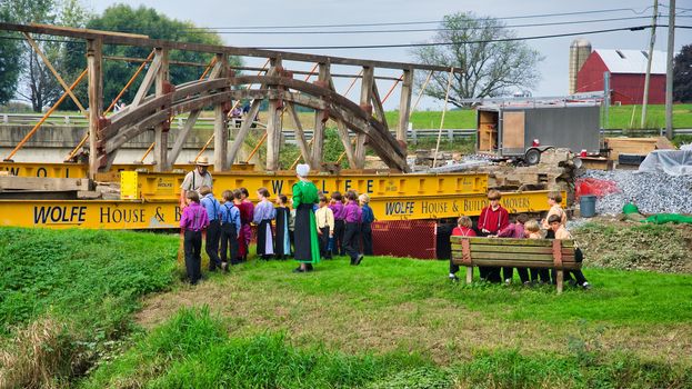 Dismantling a Burr Arch Covered Bridge With Amish Children Watching as Seen on a Spring Day