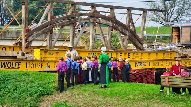 Dismantling a Burr Arch Covered Bridge With Amish Children Watching as Seen on a Spring Day