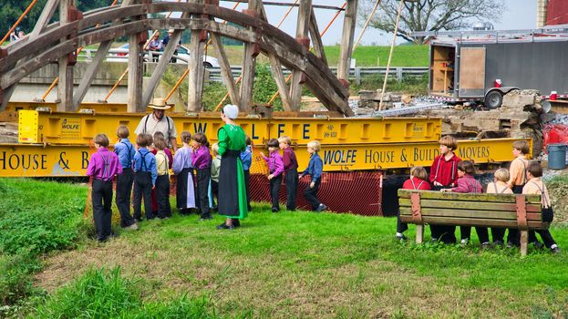 Dismantling a Burr Arch Covered Bridge With Amish Children Watching as Seen on a Spring Day