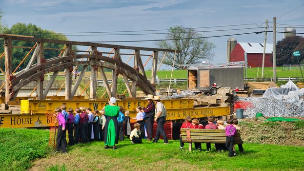 Dismantling a Burr Arch Covered Bridge With Amish Children Watching as Seen on a Spring Day