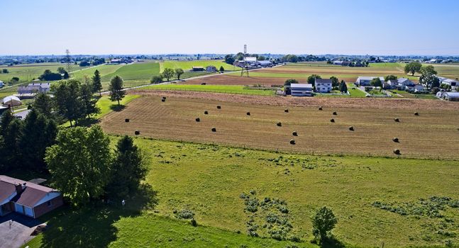 Aerial View of Amish Farmers Harvesting there Crops in Summer