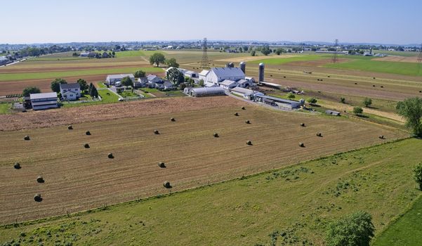 Aerial View of Amish Farmers Harvesting there Crops in Summer