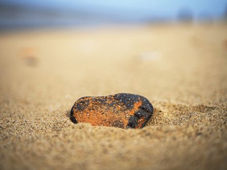 Heart shaped stone on the sand. Valentine day concept