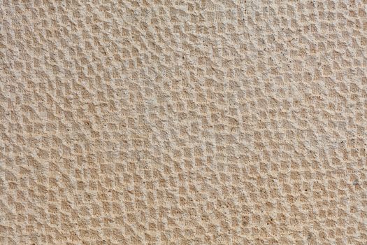 Beautiful uniform beige stone pattern on the wall of shell and stucco.