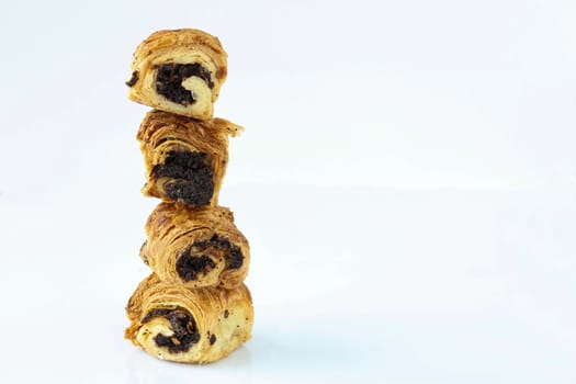 A tower of sweet rolls with poppies, which stand vertically on each other