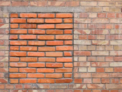 The old wall of the building with a walled red brick window, a frame for design