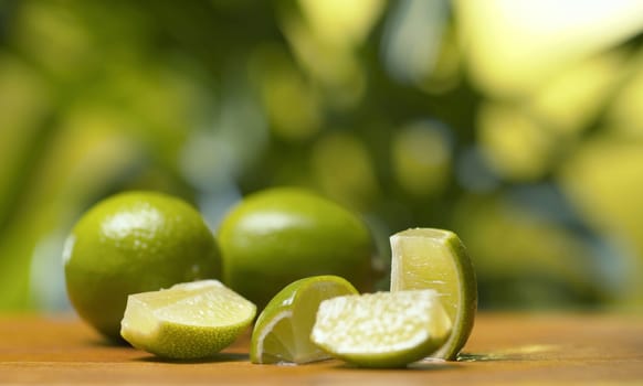Close up limes on the table on green natural background. Healthy lifestyle and eating concept.