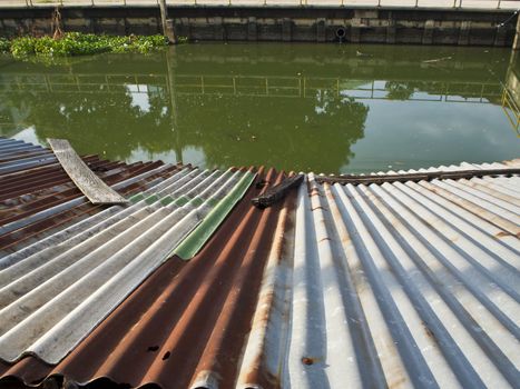 Cavities Old tin roof of the boathouse beside drainage canals