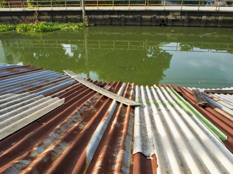 Cavities Old tin roof of the boathouse beside drainage canals