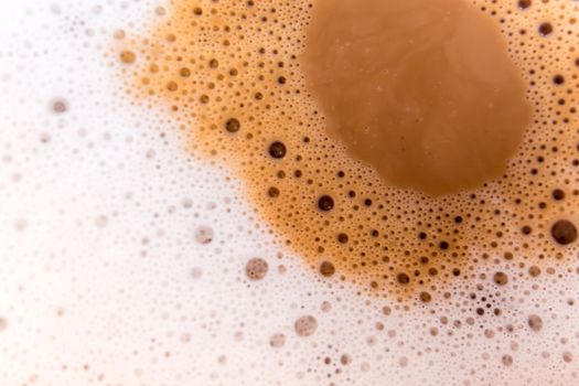 Surface texture of hot milk coffee and soft froth, close up food background