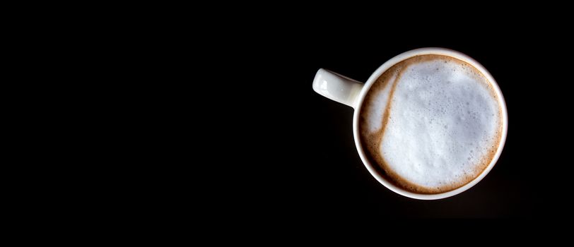 Hot milk coffee and soft froth in white ceramic cup