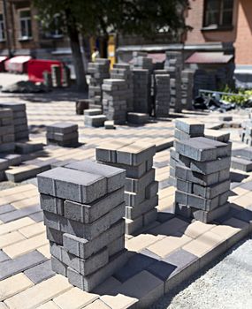 Laying of paving slabs on the construction site for the street pavement of the city