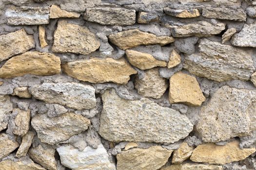 Stone wall of old limestone stones. Abstract texture