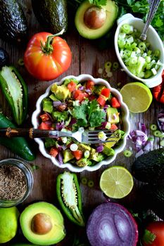 Avocado and tomatoes salad with cheese and onion and lemon and pepper