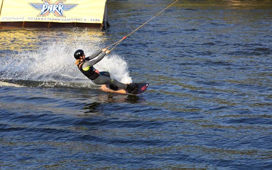 Woman practicing wakeboarding on the lake. This is an extreme sport.