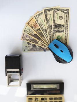 Business concept: computer mouse, seal, old calculator, money located opposite each other on a white background