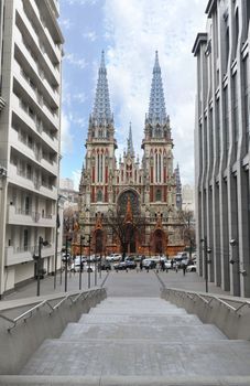 The facade of the Roman Catholic Cathedral of St. Nicholas in Kiev against the blue sky and white clouds, February 2018, Ukraine.