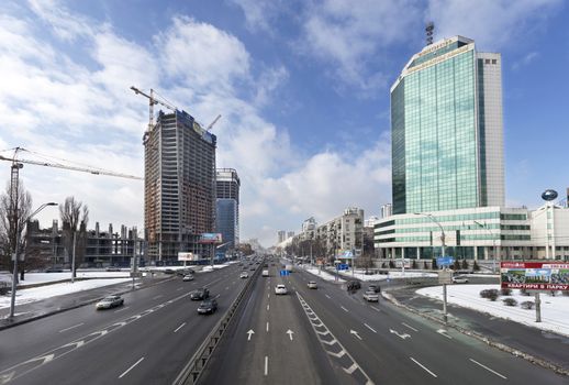 Kyiv, Ukraine. View over city traffic on Peremogi Prospect with Ministry of Infrastructure building in the background.