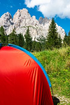 Red Tent in Mountains. Outdoor Adventure and Leisure Pursuit Concept.