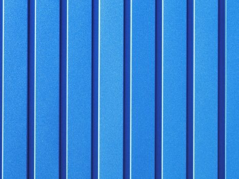 Light blue metallic fence made of corrugated steel sheet with vertical guides. Corrugated Light blue iron sheet background close up.